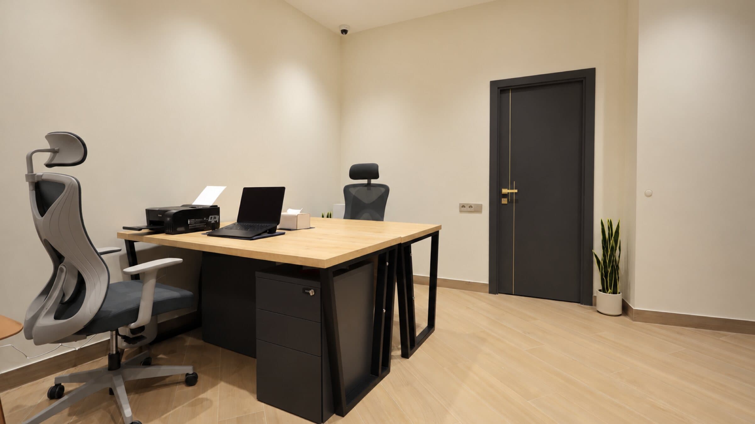 Office with a desk, ergonomic chair and printer