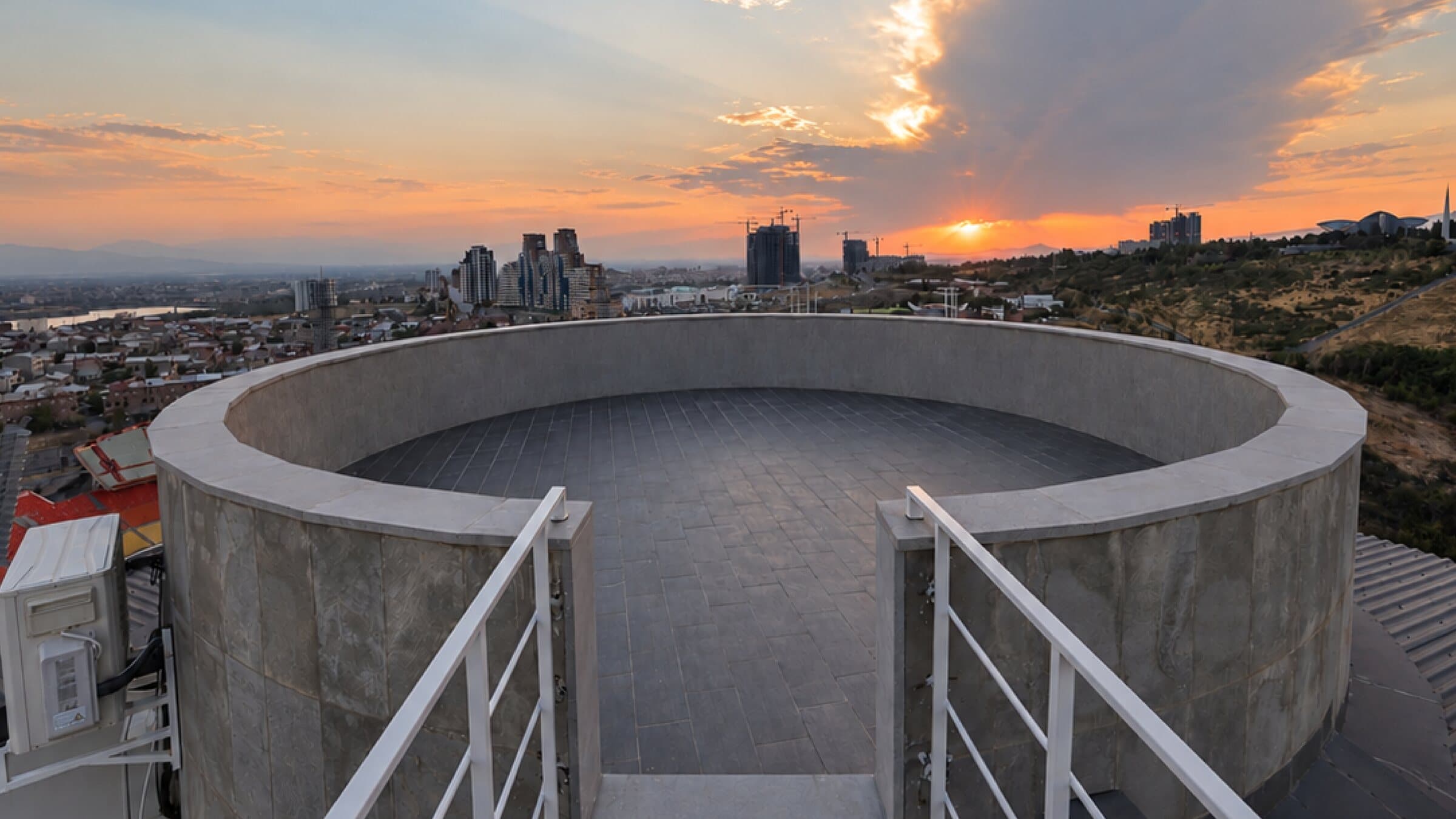 Round rooftop platform at sunset over Yerevan