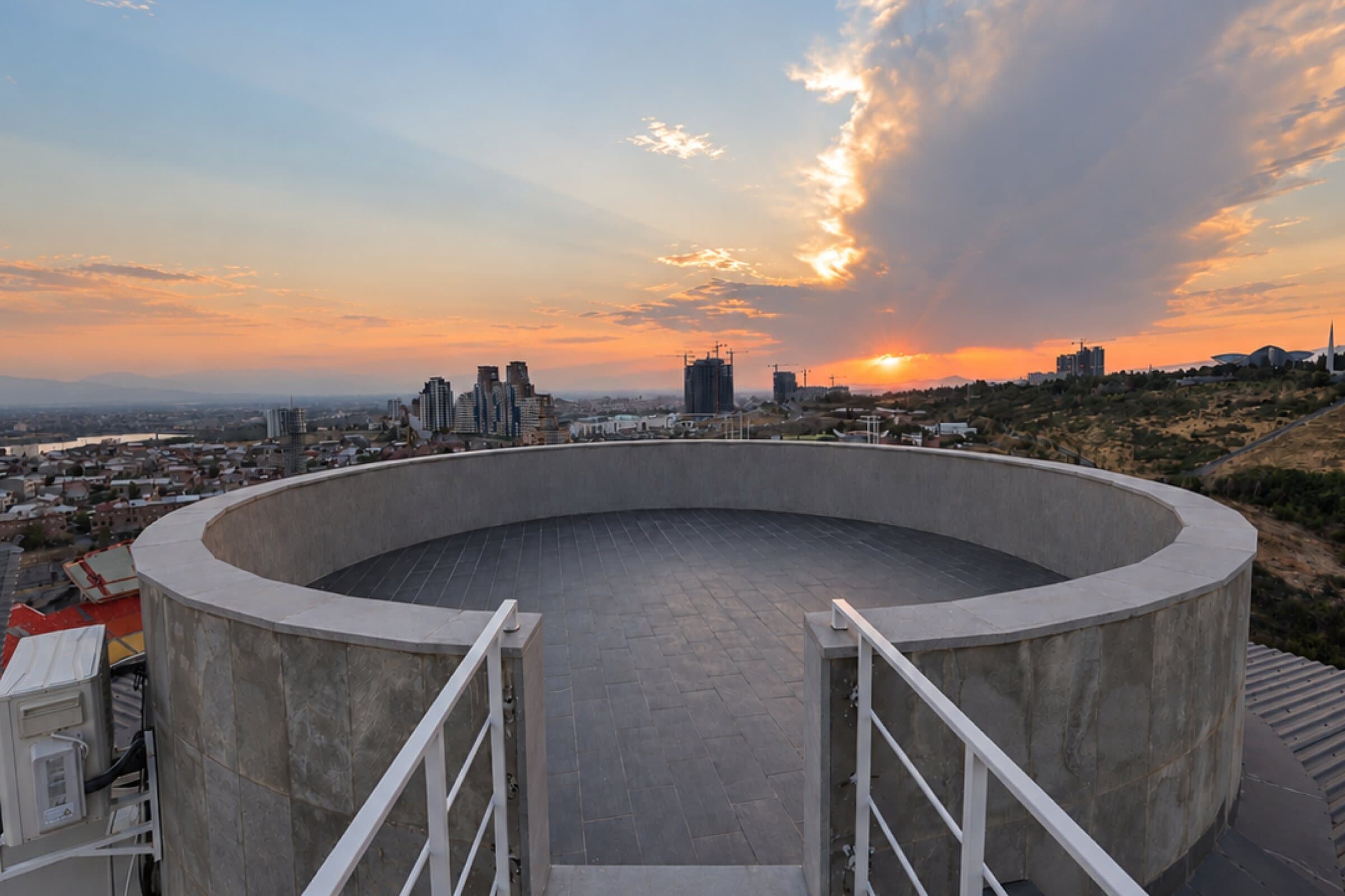 Round rooftop platform at sunset over Yerevan