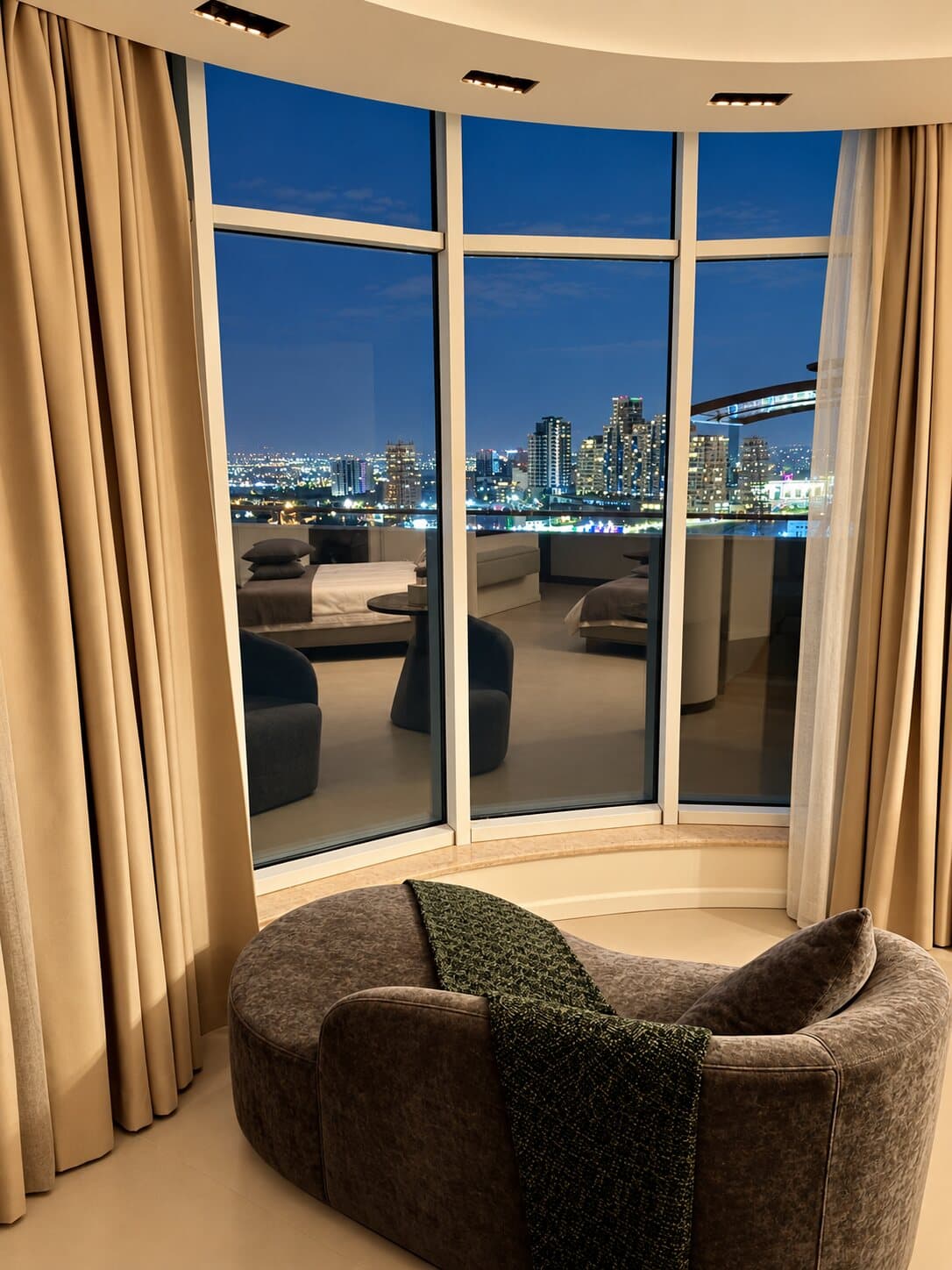 Armchair by the curved window with a night view