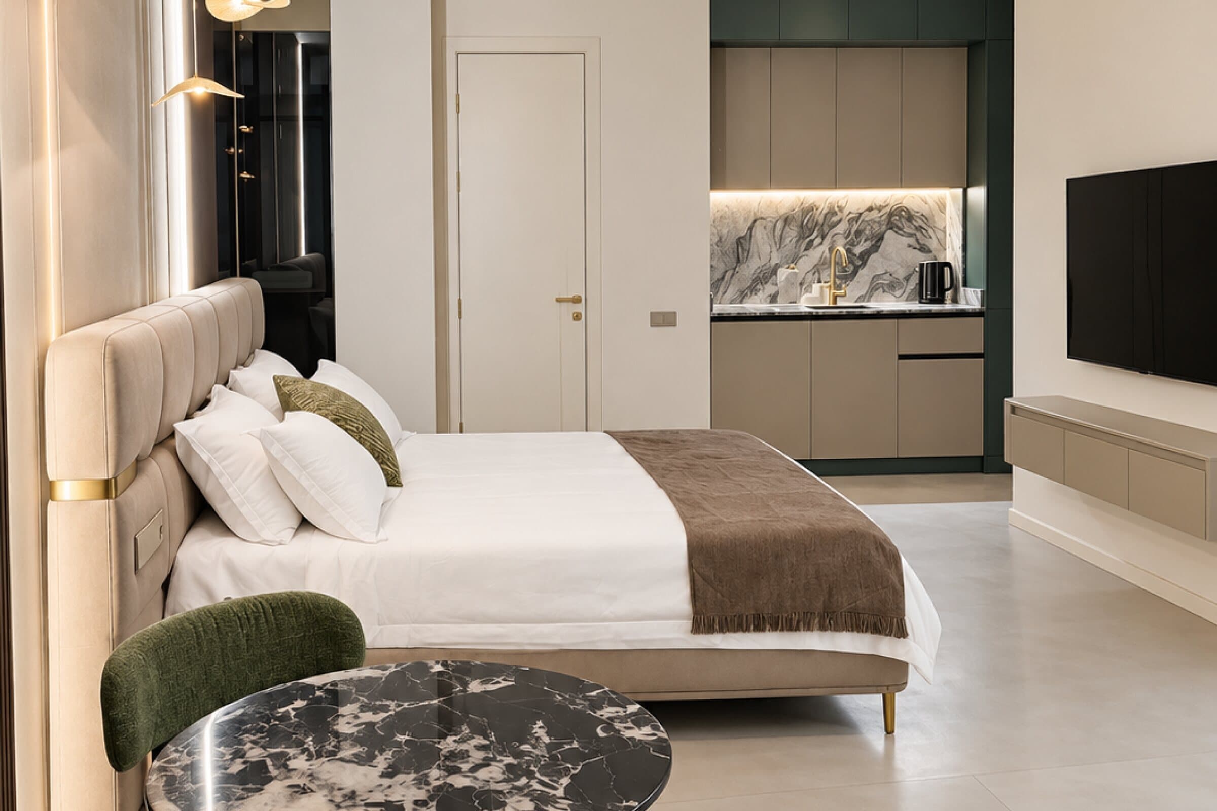 Suite bedroom with a double bed, kitchenette and TV
