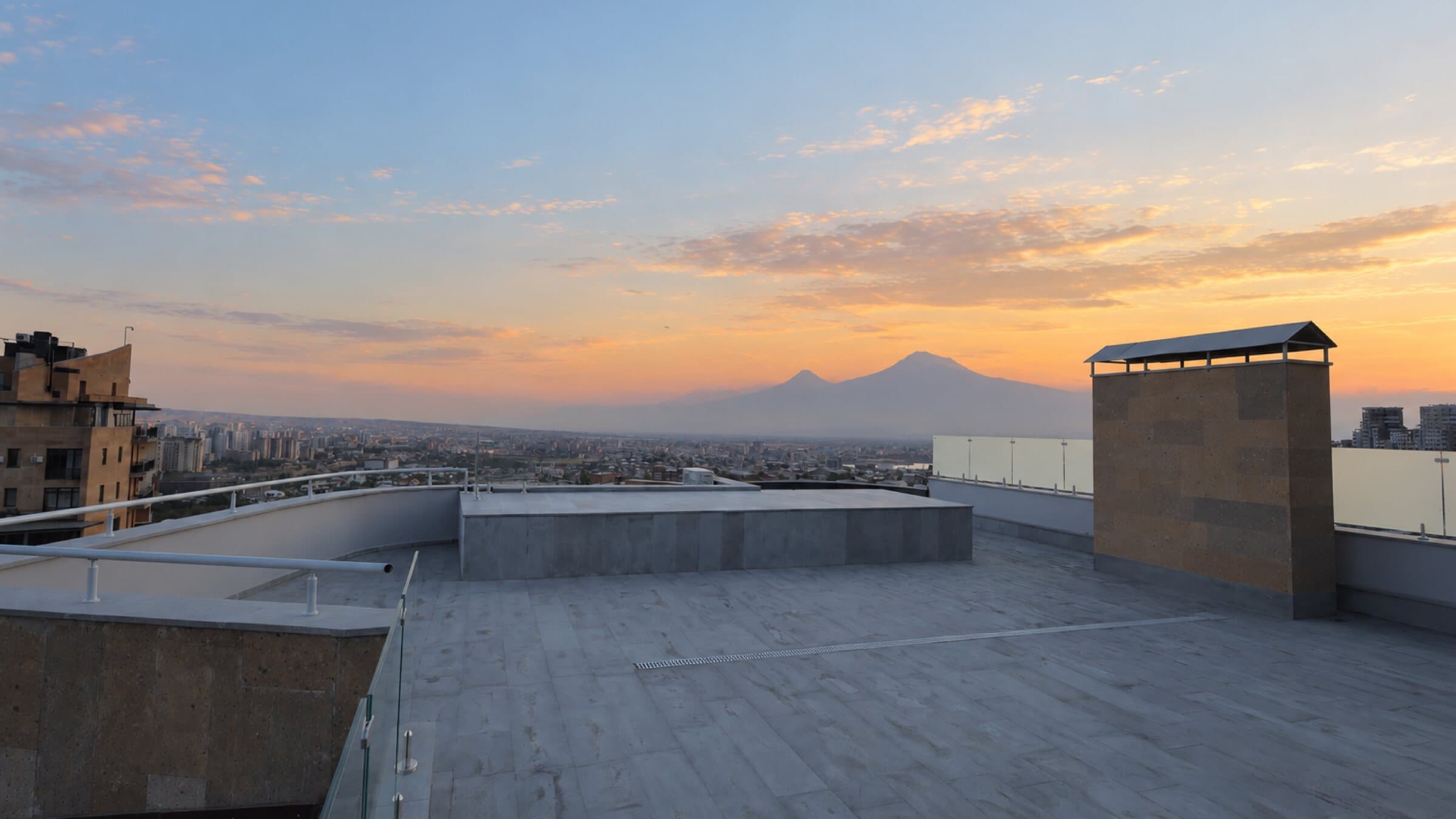 Open rooftop terrace at sunset with Mount Ararat on the horizon