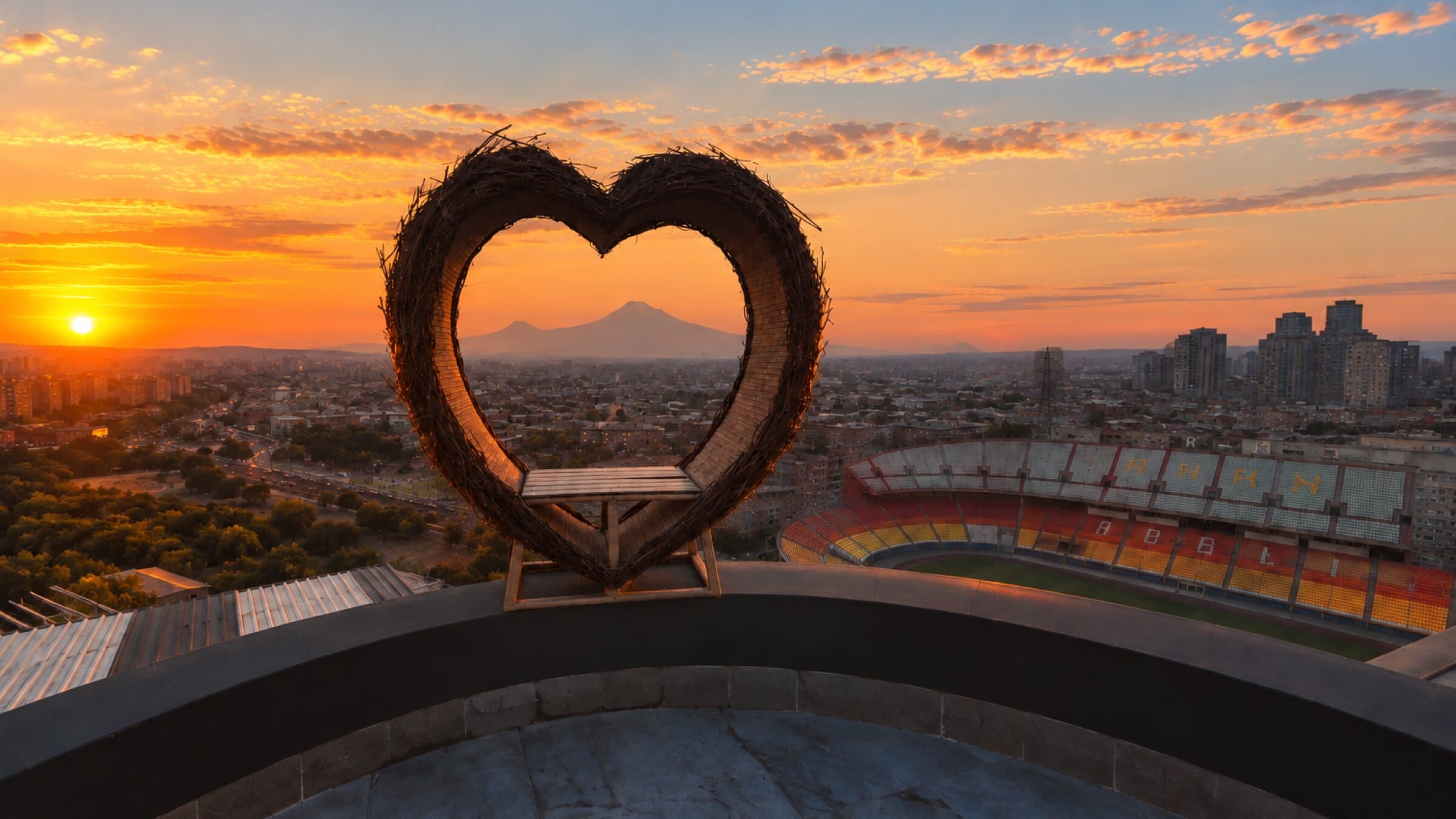 Heart-shaped frame on the rooftop at sunset