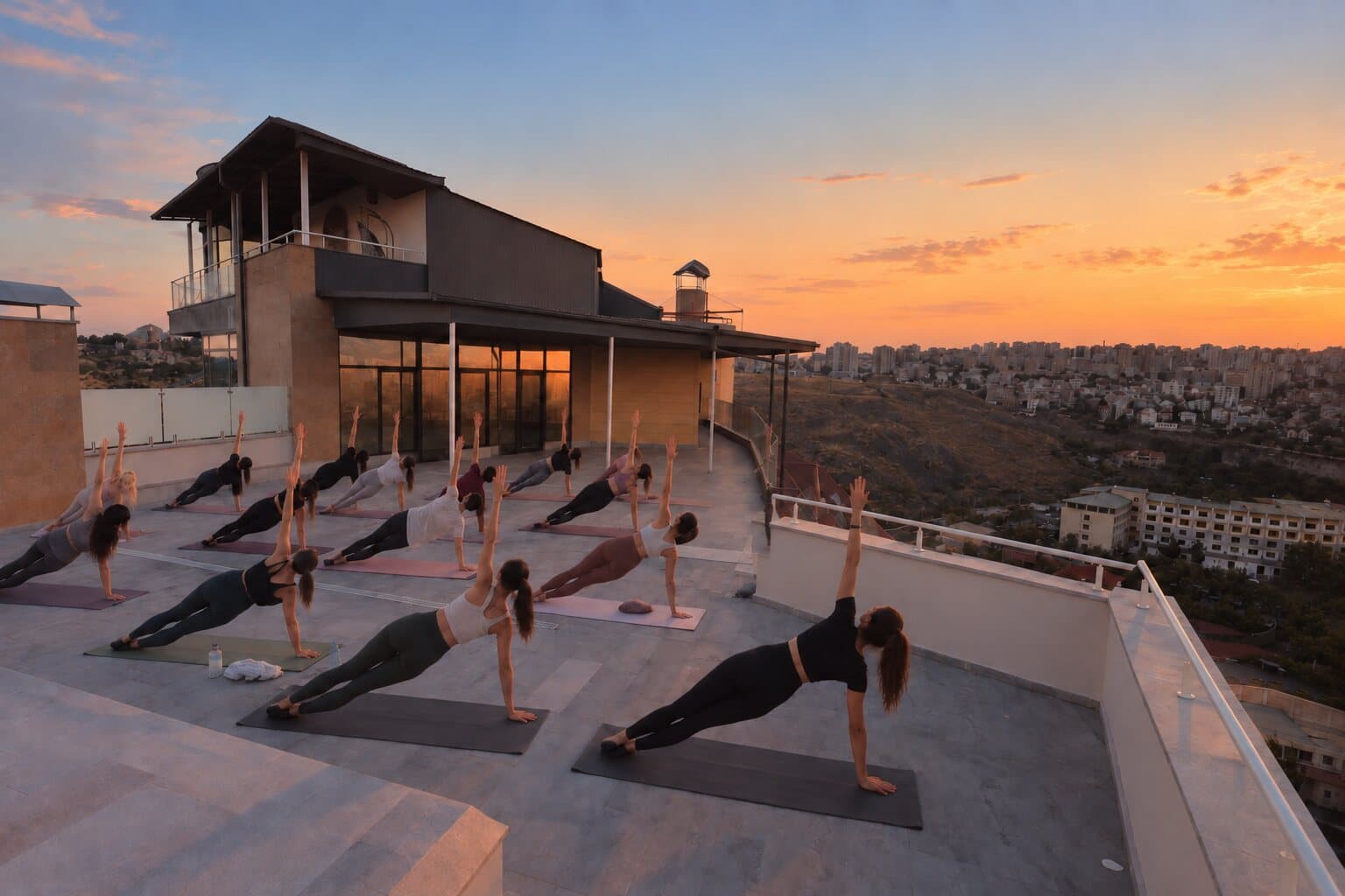 Yoga class beside the rooftop pavilion