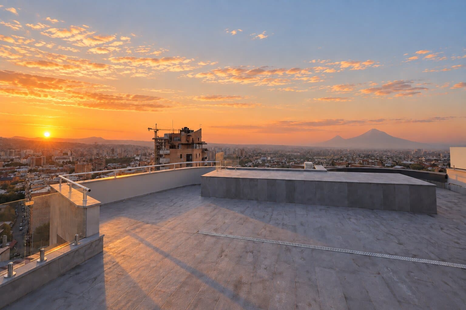 The empty rooftop at sunset with the city around it