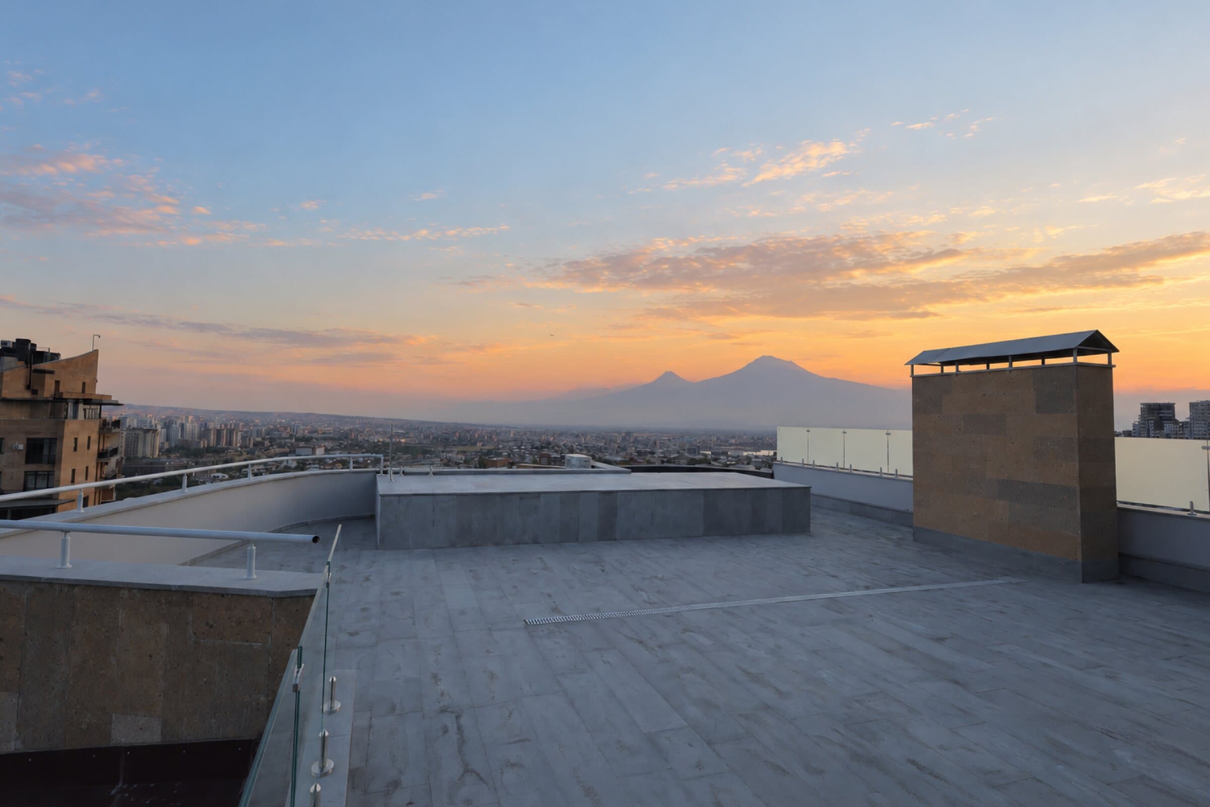 Open rooftop terrace at sunset with Mount Ararat on the horizon