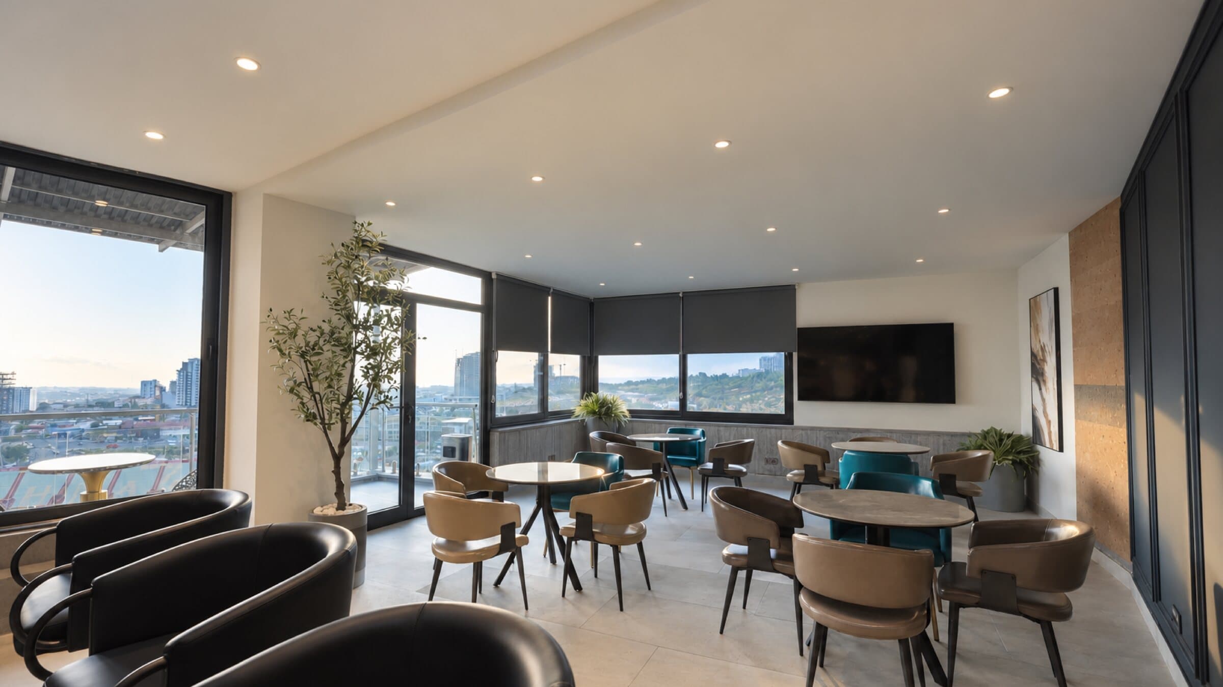 Café lounge with leather armchairs, tables and panoramic windows