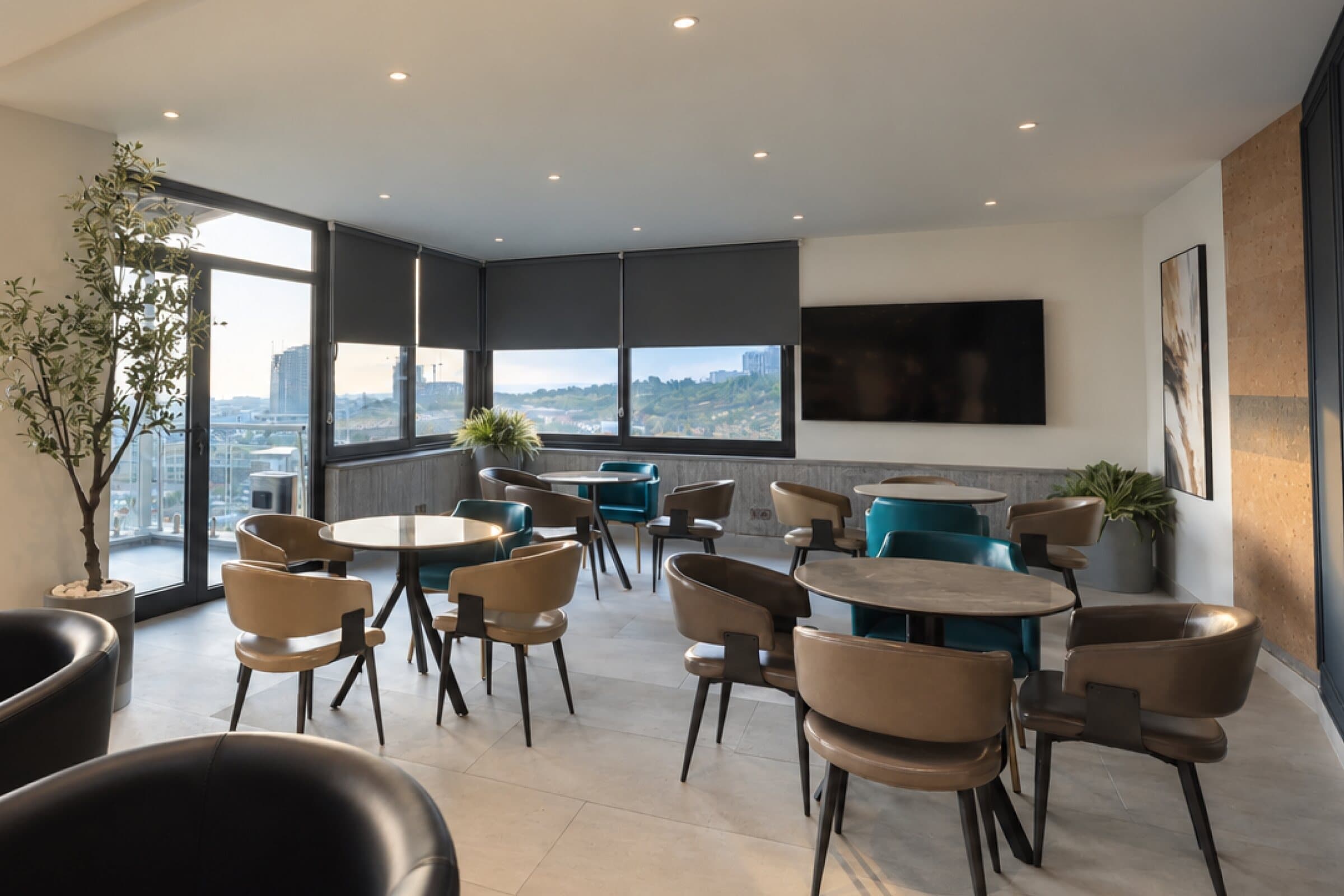 Café tables and leather chairs by the panoramic windows