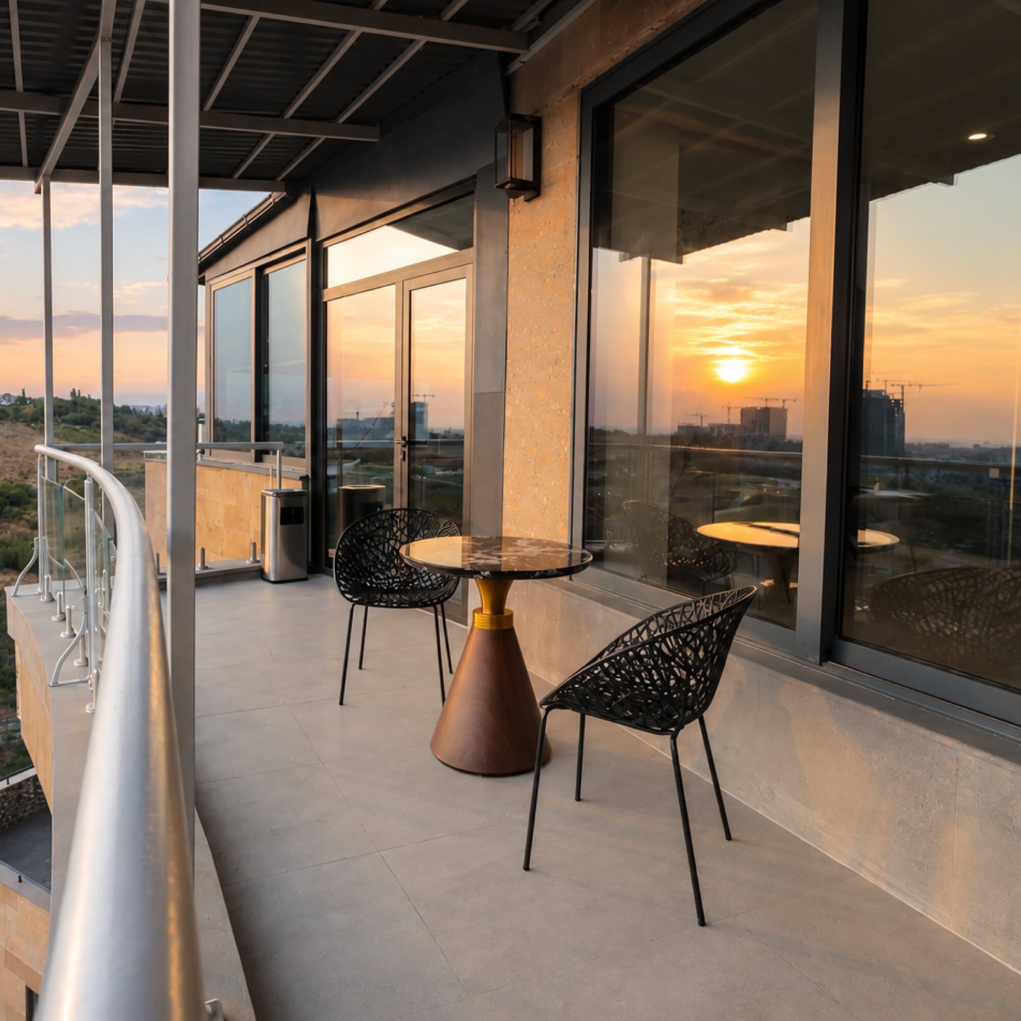 Balcony with a small table at sunset
